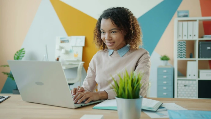 Young woman working on a laptop at a desk